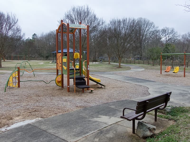 Playground equipment and a bench at a Townsville neighborhood park